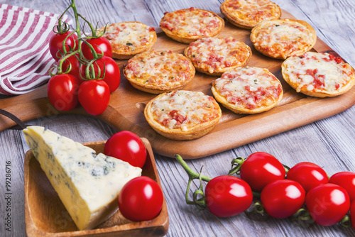 Mini pizzas on a wooden table