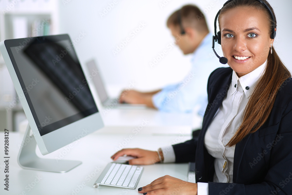 Happy female wearing headset and sitting on the desk Happy female wearing headset and sitting on the desk