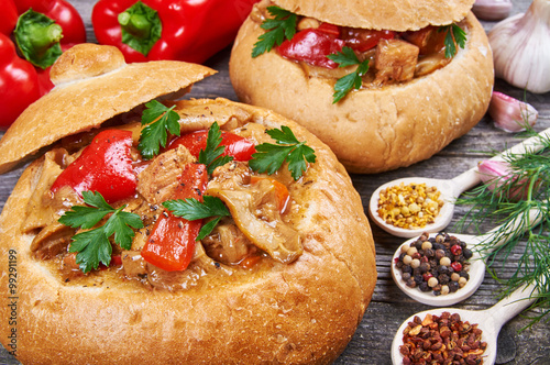 Stew made from meat, vegetables and mushrooms in a bread bowl