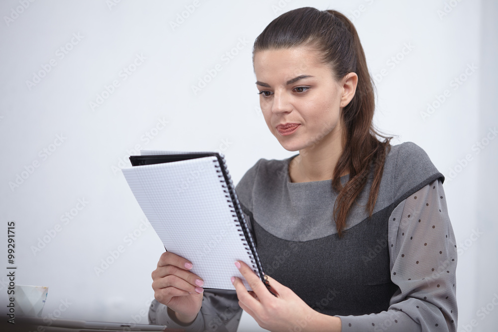 Business lady with a notepad in the office Business lady with a notepad in the office