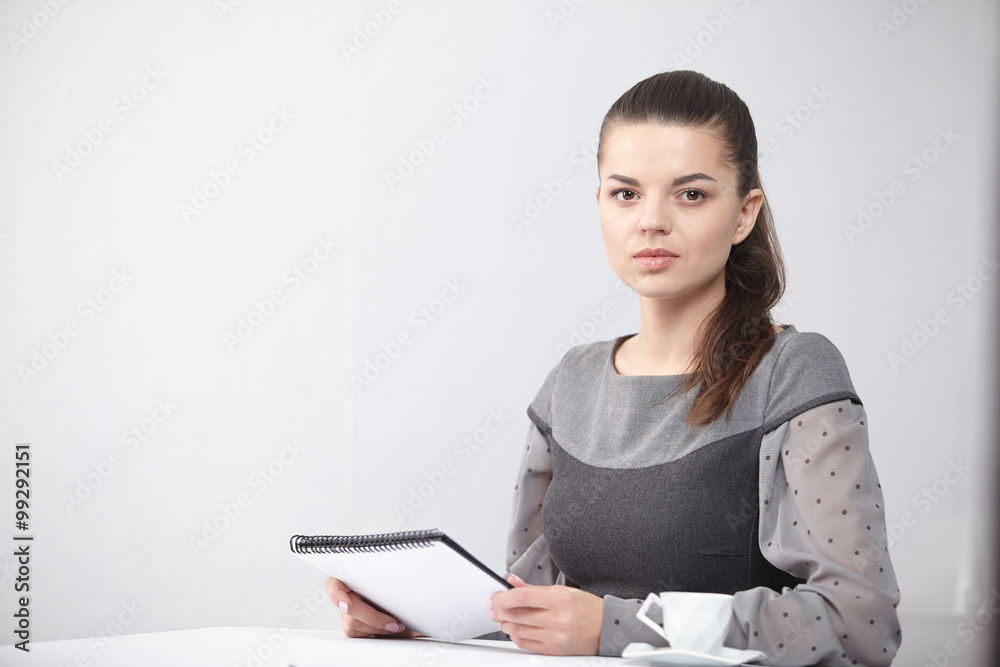 Business lady with a notepad in the office Business lady with a notepad in the office