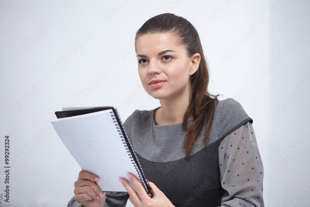 Business lady with a notepad in the office Business lady with a notepad in the office