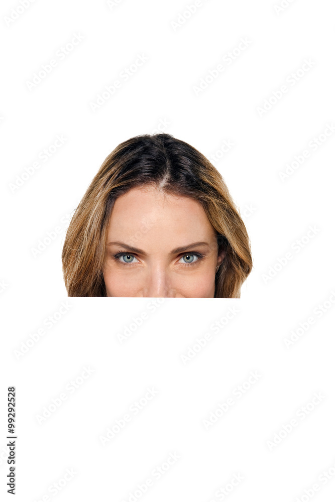 Behind a white board - Woman hiding or peeking behind a white sign Behind a white board - Woman hiding or peeking behind a white sign
