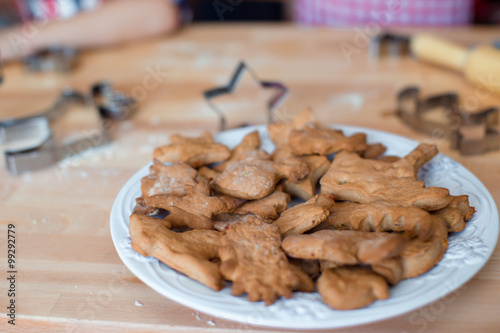 Tasty Christmas cookies on plate during winter vacation