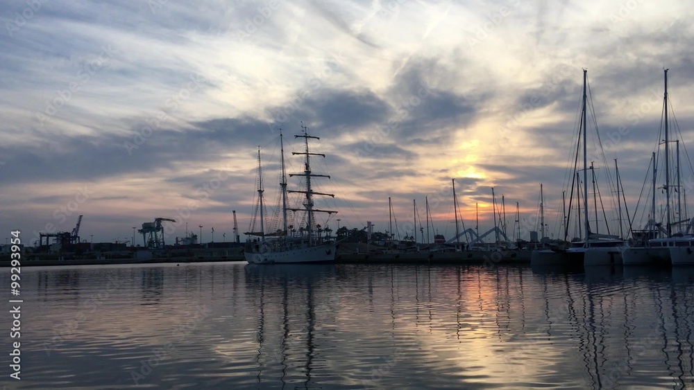 Valencia, Spain - December 27, 2015: yachts in sunset lighting in america's cup port, in Valencia. Witch known as Marina Real Juan Carlos I, place for sport competitions. Valencia, Spain - December 27, 2015: yachts in sunset lighting in america's cup port, in Valencia. Witch known as Marina Real Juan Carlos I, place for sport competitions.