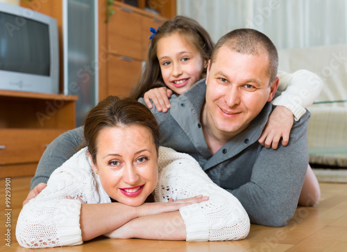 Family smiling at the floor