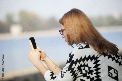 Pretty Girl Using Mobile Phone Outdoor
