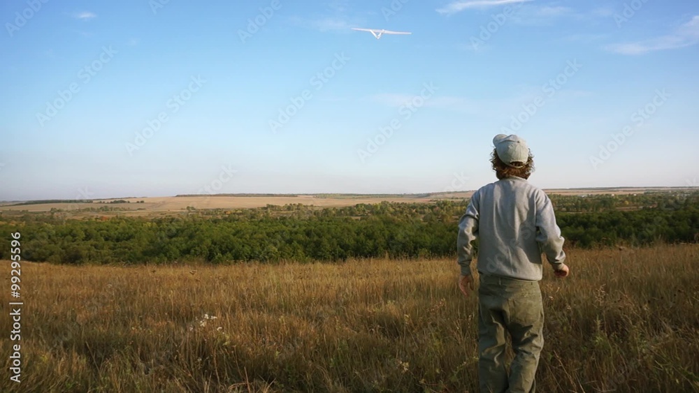 Happy Child Playing with an airplane on a meadow
Happy Child Playing with an airplane on a meadow