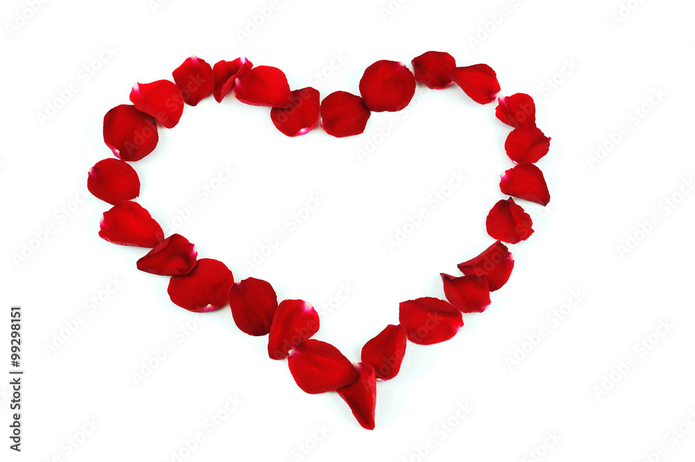 red heart by rose petals on white background