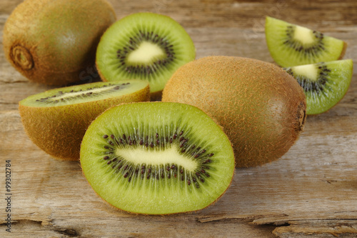 Kiwi fruit sliced on old wooden