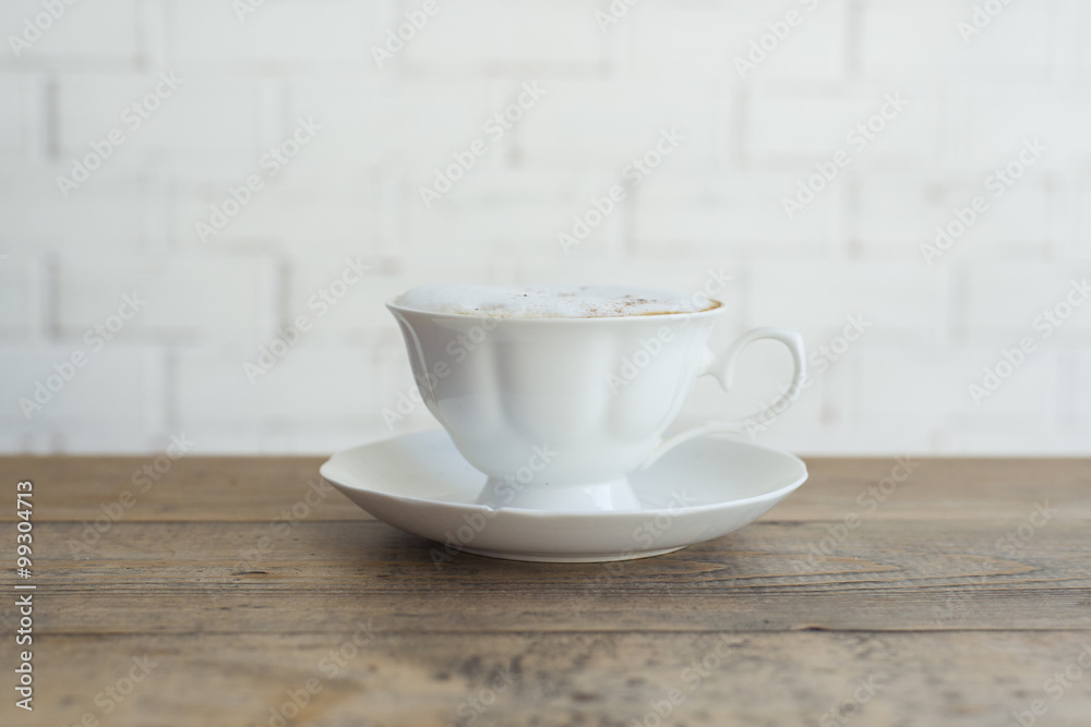 Hot cappuccino on wood background