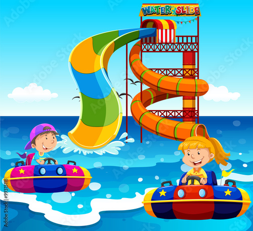 Boy and girl riding on water slide in the ocean