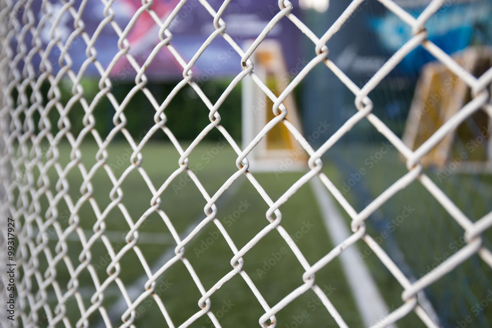 Fototapeta premium white metal grate fence texture and sport field background