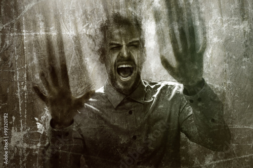 Fotografie Scary guy behind a dirty window