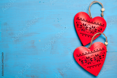 Red hearts on blue wooden background. Symbol of love in valentine's day.
