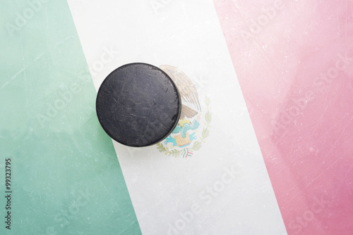 old hockey puck is on the ice with mexico flag