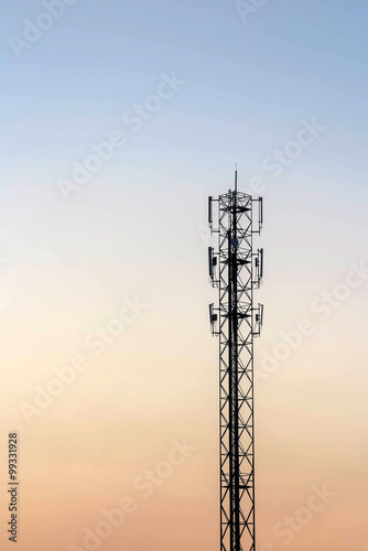 Telecommunication cellular tower on twilight background. Used to
