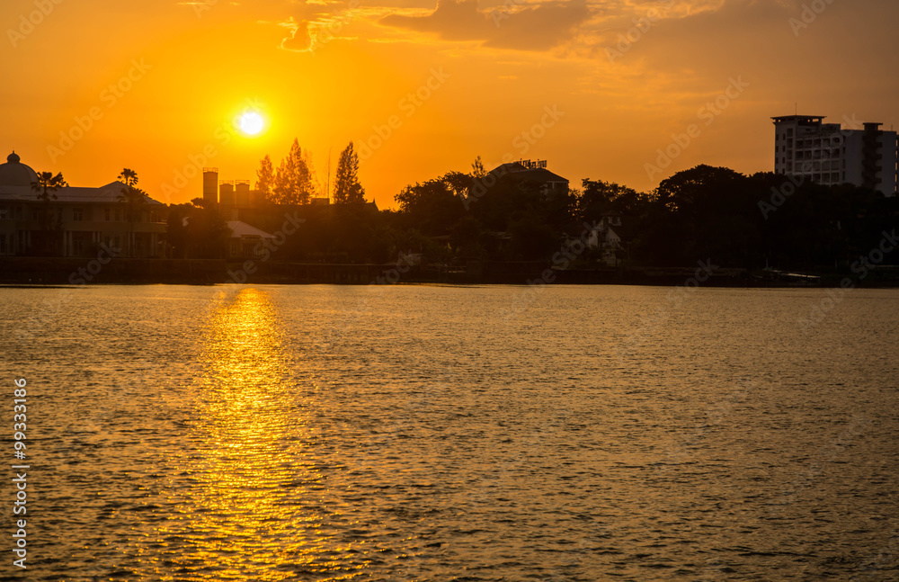 Fototapeta premium sunrise over river with gold reflection wave