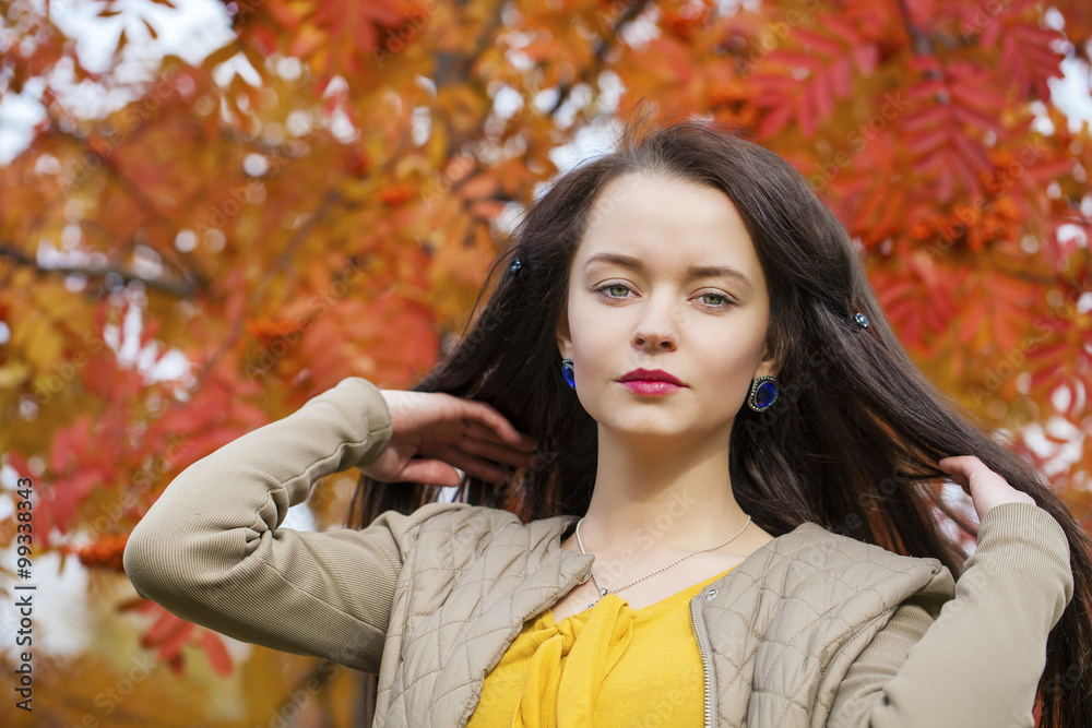 Young beautiful brunette woman posing outdoors in autumn park Young beautiful brunette woman posing outdoors in autumn park