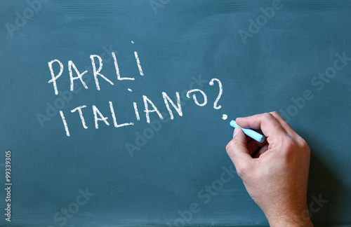 male hand writing over chalkboard do you speak italian
 photo