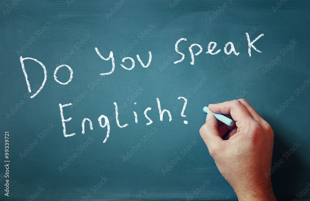 the question do you speak english written on chalkboard and male hand
the question do you speak english written on chalkboard and male hand