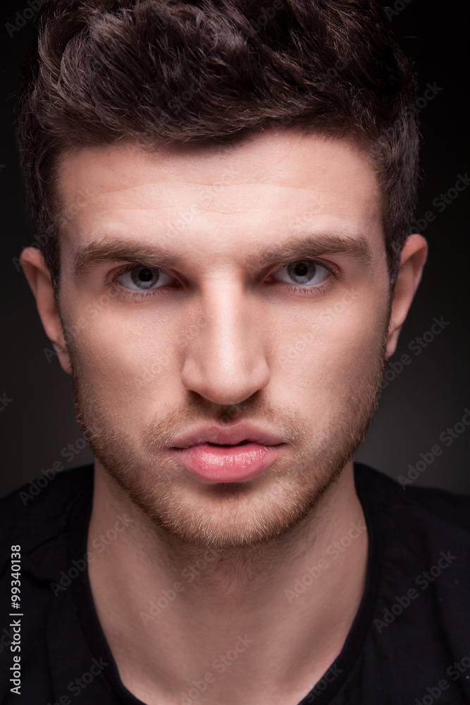 Stylish guy close up portrait on black background Stylish guy close up portrait on black background