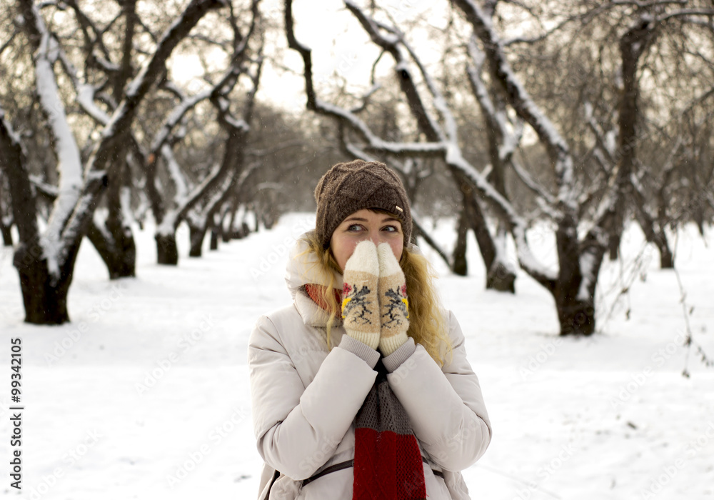 Young beautiful girl close up in winter park enjoys snow fell Young beautiful girl close up in winter park enjoys snow fell