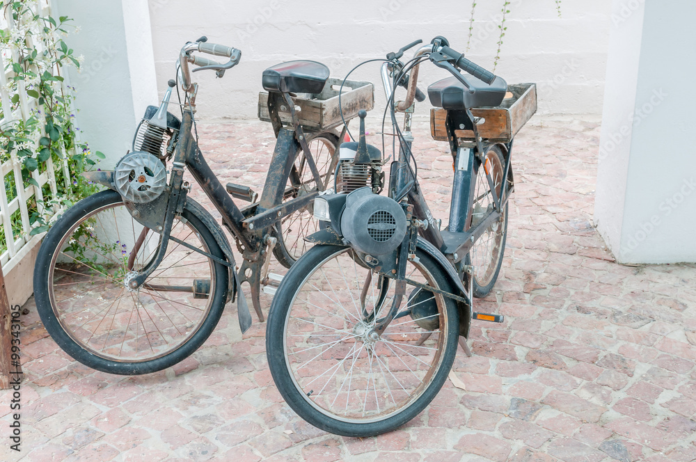 Two vintage motorised bicycles