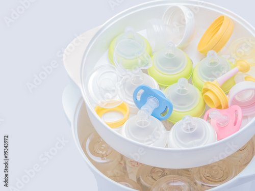 Wallpaper Mural Nipples and milk bottle in steam sterilizer and dryer. Torontodigital.ca