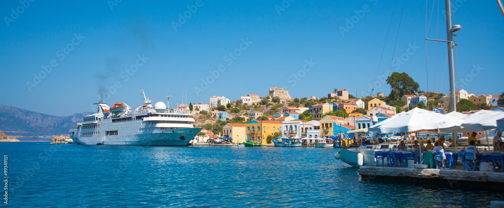 Panoramic view of mediterranean Greek island Kastellorizo (Megisti), nearest to the Turkey. Harbour with ship ( vessel) Lovely place of travelers and yachtsmen. Passengers boat
