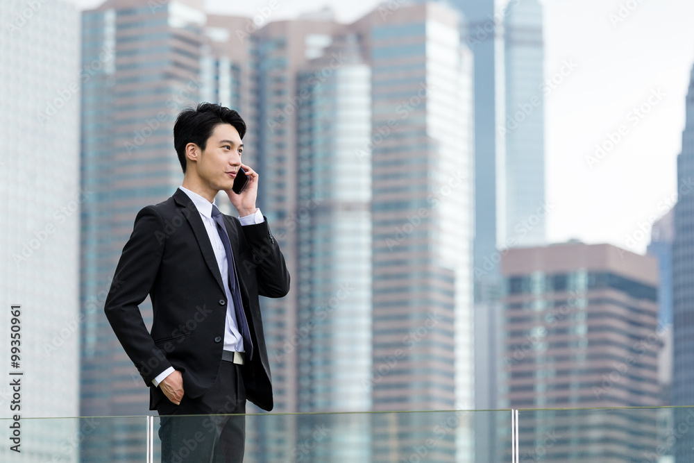 Businessman make a call on cellphone at outdoor Businessman make a call on cellphone at outdoor