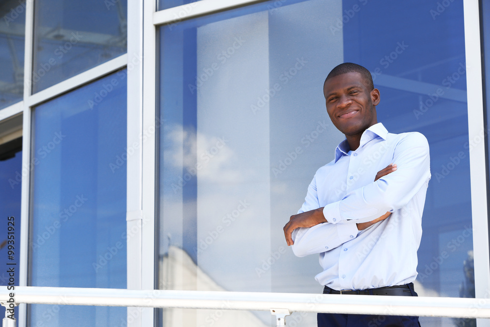 Handsome African American businessman near business centre Handsome African American businessman near business centre