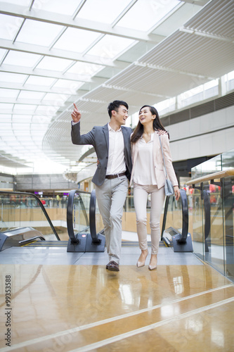 Young couple walking in shopping mall