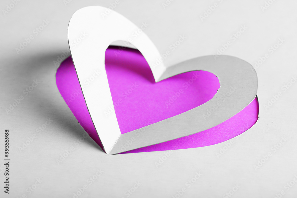 Cut out white paper heart on purple background Cut out white paper heart on purple background