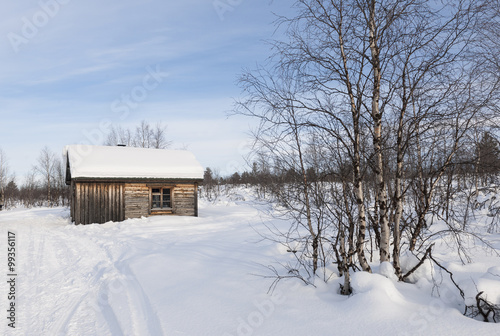 Small House On Snow Covered Field