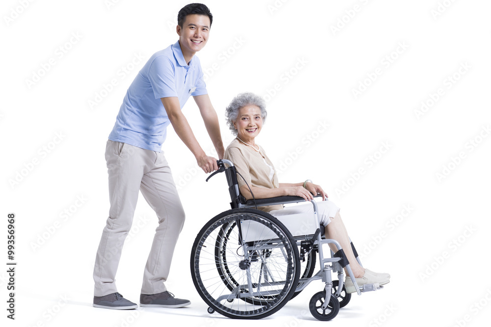 Male nursing assistant taking care of senior in wheelchair Male nursing assistant taking care of senior in wheelchair