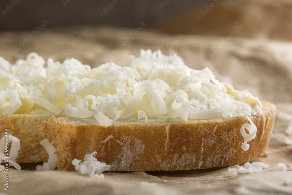 Bread with butter and grated cheese