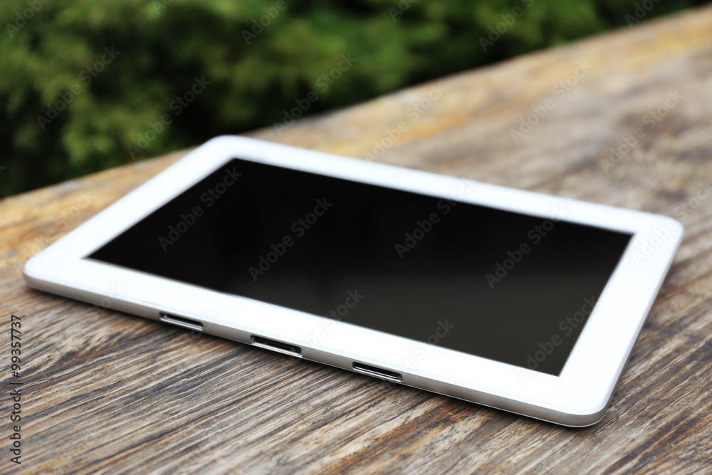 Tablet on wooden table Tablet on wooden table