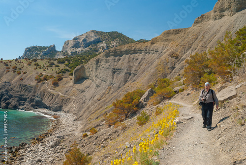 Mature man hiking on a Golitsyn path near Koba-Kaya mountain in Noviy Svet  resort on a Black Sea shore  Crimean peninsula