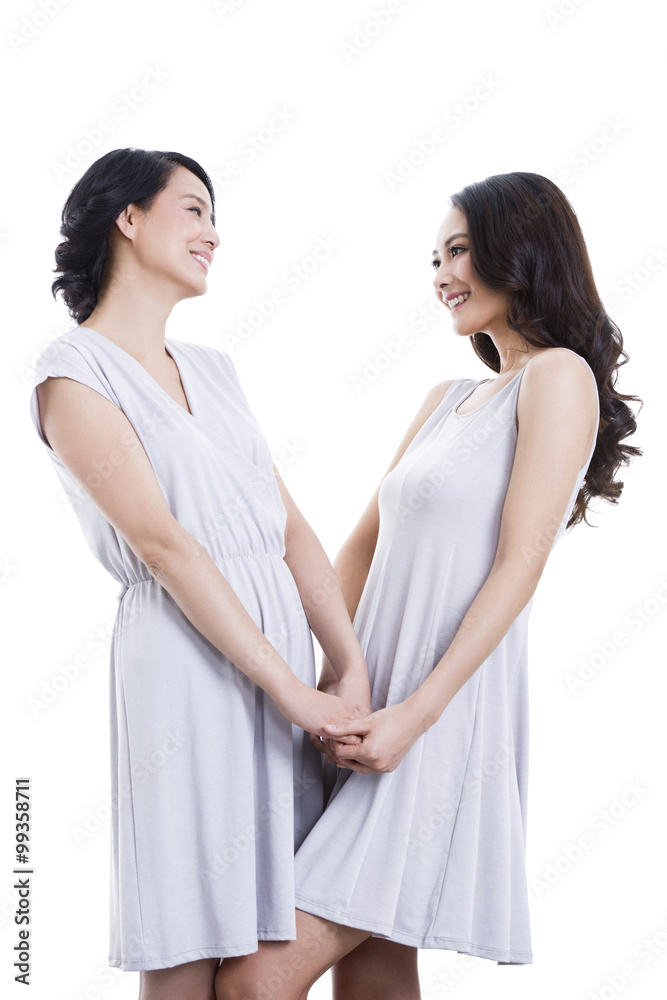 Cheerful mother and daughter holding hands Cheerful mother and daughter holding hands