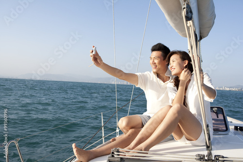 Happy couple taking self portrait on the boat deck © Blue Jean Images