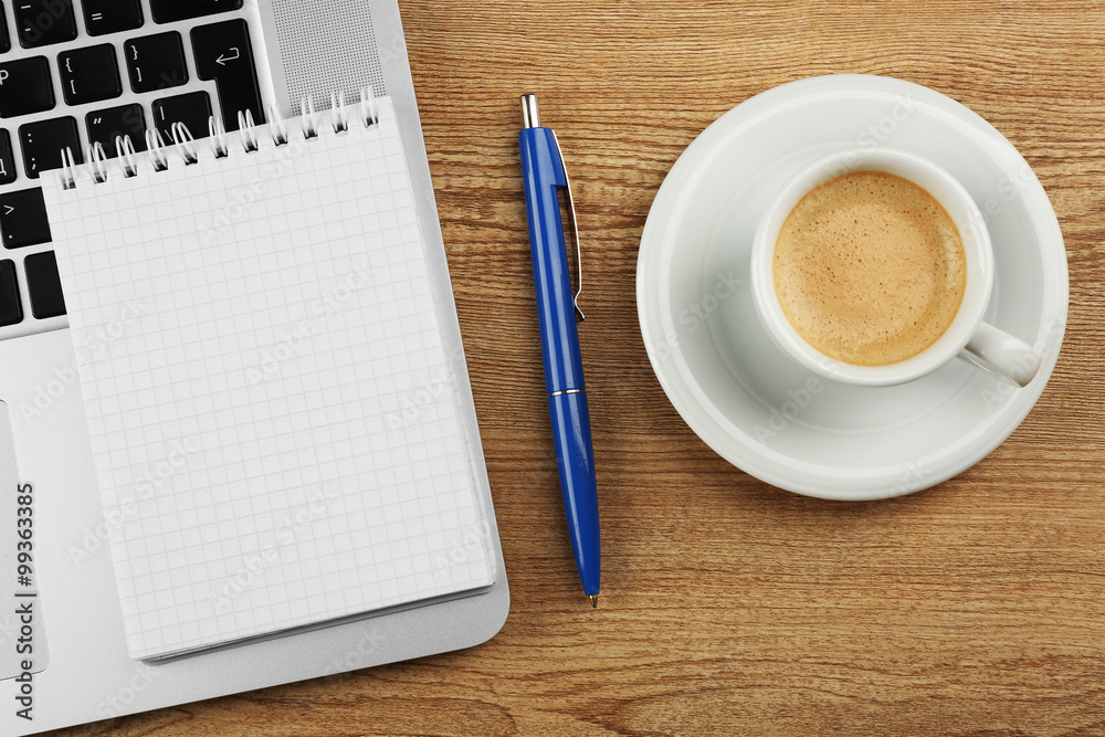 Empty notebook on laptop keyboard, on light background Empty notebook on laptop keyboard, on light background