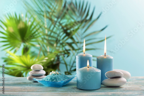 Blue candles with spa salt on table