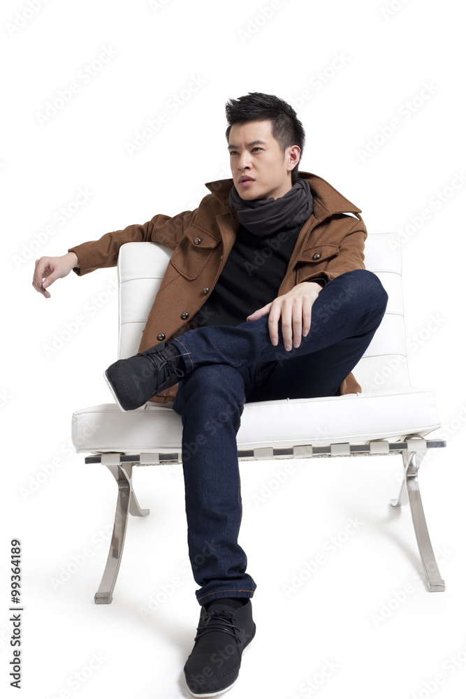 Stylish young man sitting on a chair