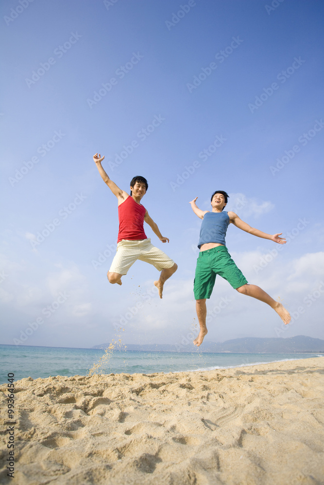 Two young men excited to be at the beach Two young men excited to be at the beach
