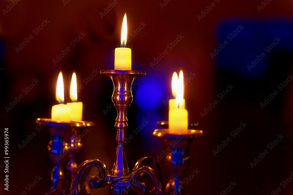 silver chandelier and burning candles on decorated wedding table. silver chandelier and burning candles on decorated wedding table.