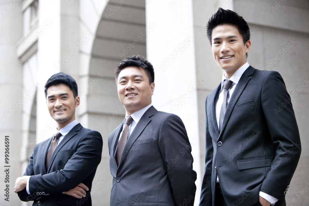Portrait of confident business team in front of a building, Hong Kong Portrait of confident business team in front of a building, Hong Kong