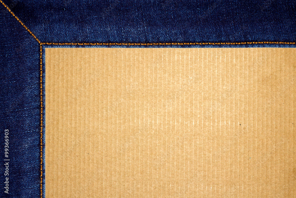 Fototapeta premium Frame of stitched blue jeans on cardboard