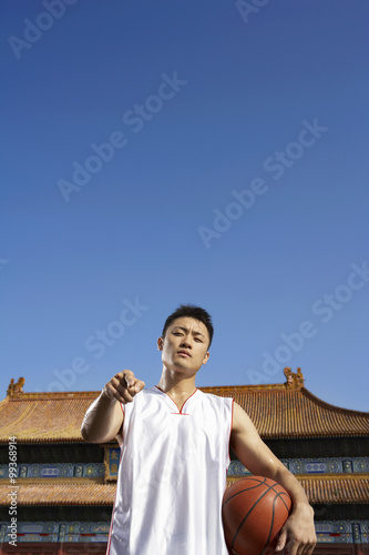 Portrait Of Young Basketball Player In Front Of Temple photo