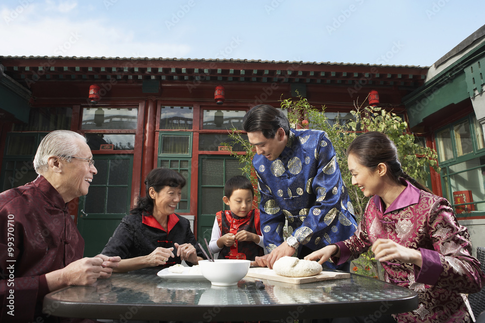 Family Making Dumplings In Courtyard